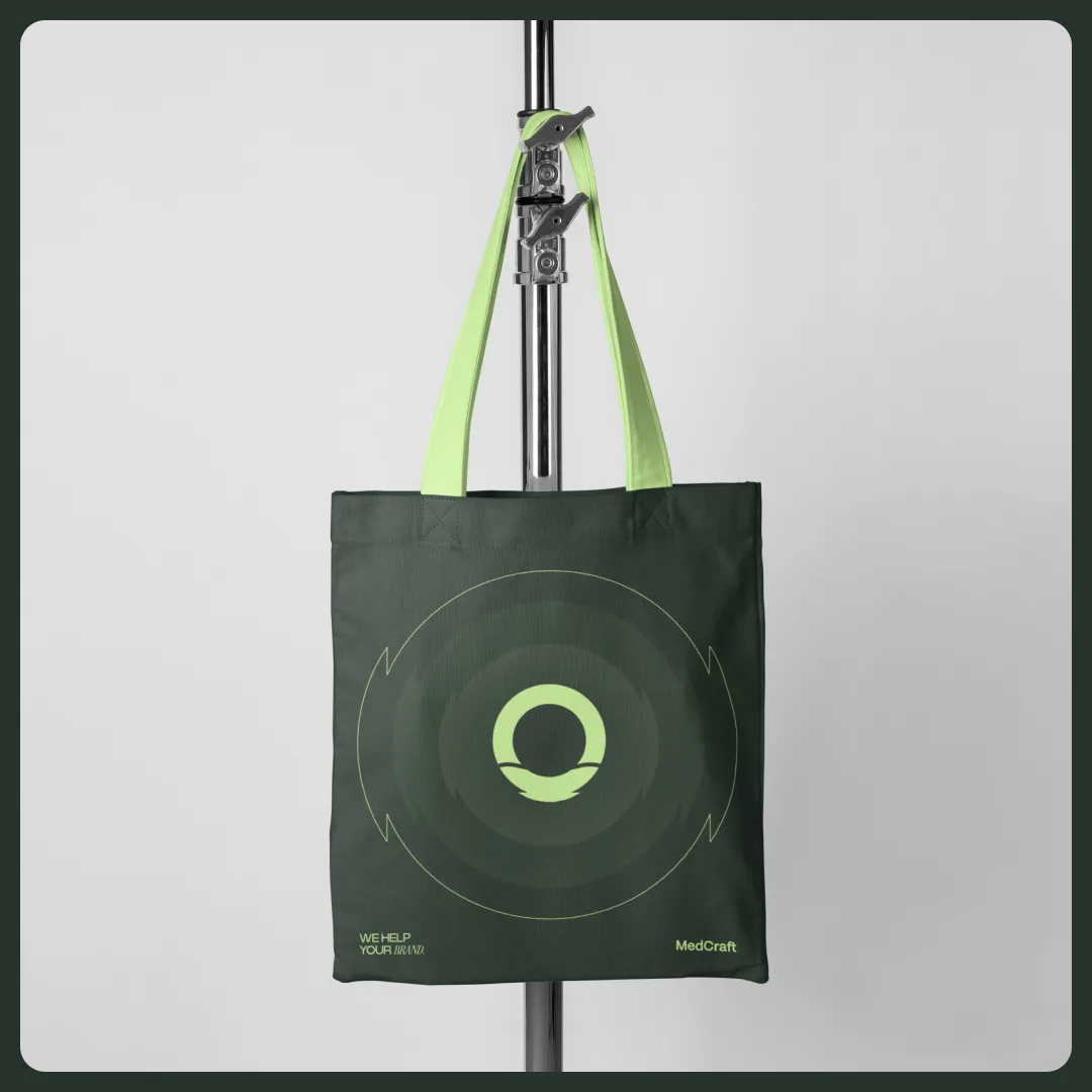 Deep green tote bag with lime handles and the ring mark in its orbit device
